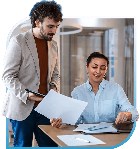 Man and Woman Collaborating Over Paperwork